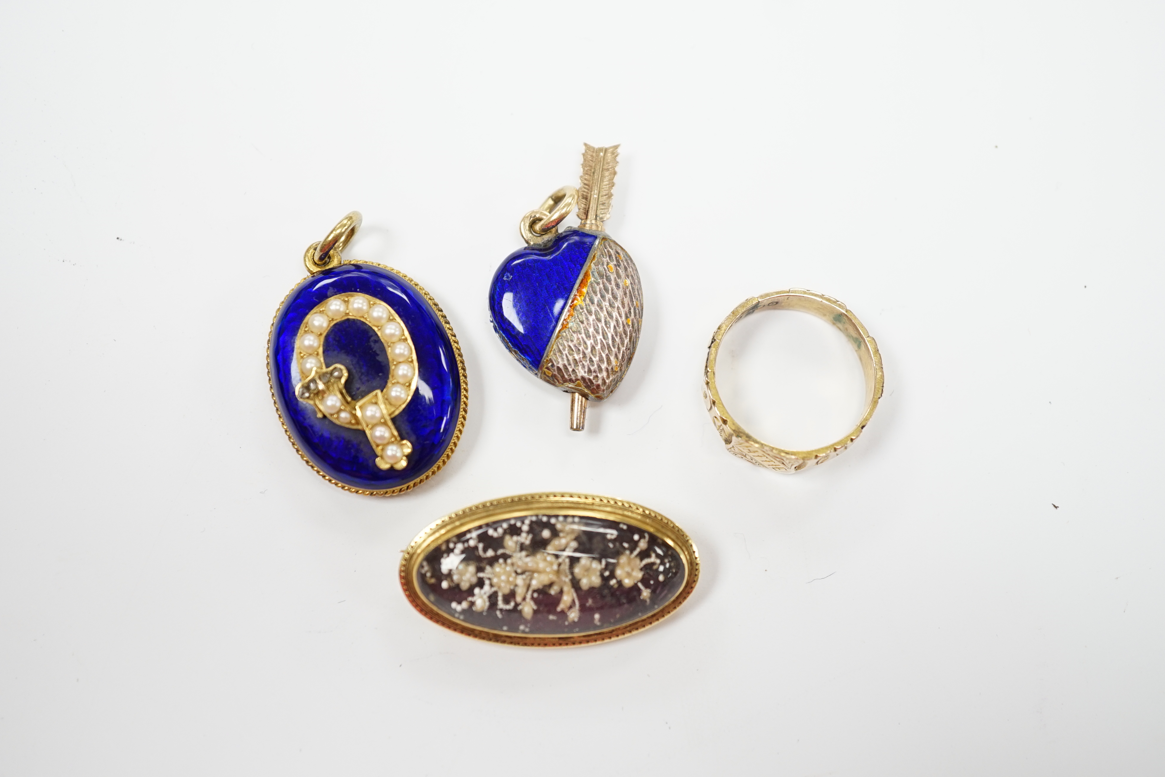 A Victorian yellow metal, blue enamel, seed pearl and rose cut diamond set oval pendant, with glazed back, 28mm, a late Victorian 9ct gold signet ring, engraved Mattie, a glazed yellow metal, enamel and seed pearl oval b